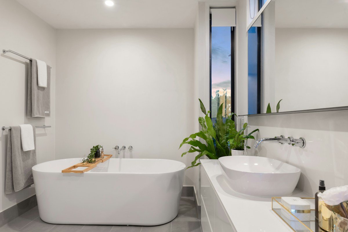 Calm bathroom with freestanding tub and pale stone — stock inspiration
