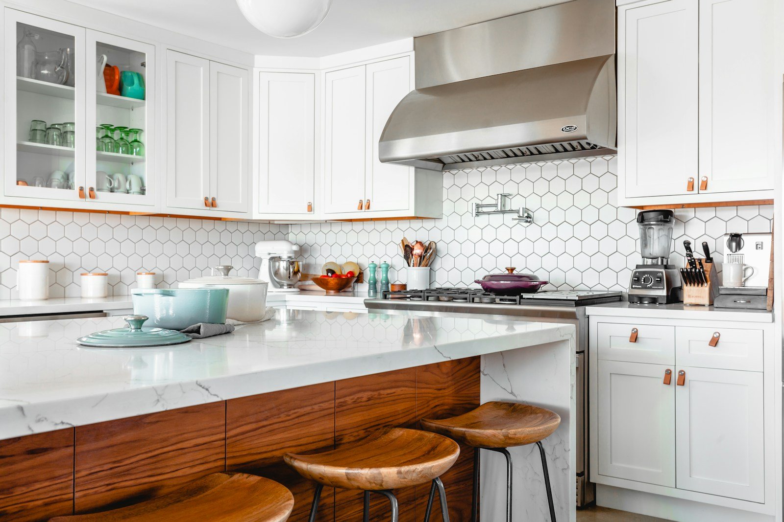 White cabinetry and warm timber island in a bright kitchen — stock inspiration